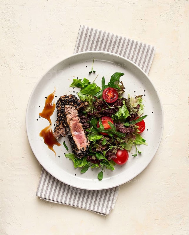 Vegetable salad, with fried tuna, in sesame seeds, healthy food, top view