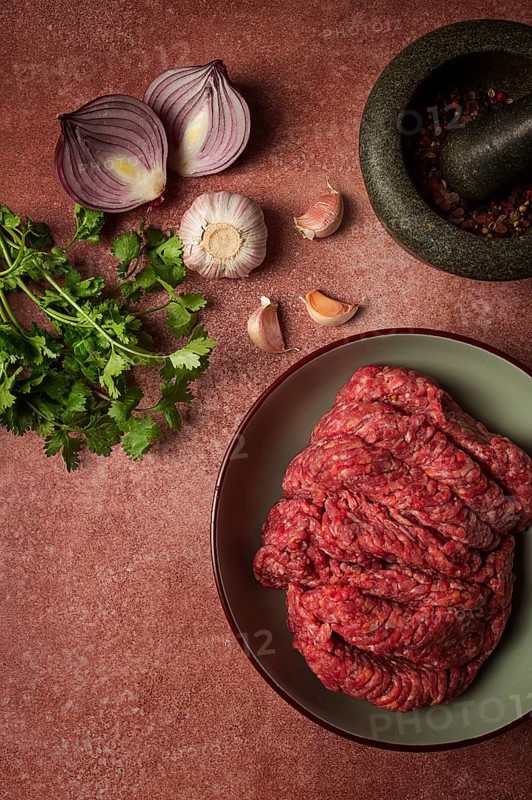 Fresh minced meat, raw, with spices and ingredients. on the table, preparation, top view