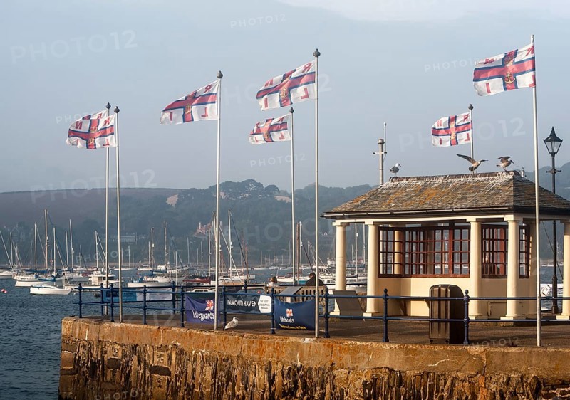 RNLI flags flying in the breeze on Prince of Wales pier, Falmouth, Cornwall, England, UK