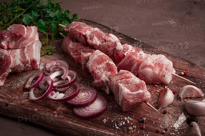 Raw pork meat, on wooden sticks, pickled kebab, with spices, top view, no people