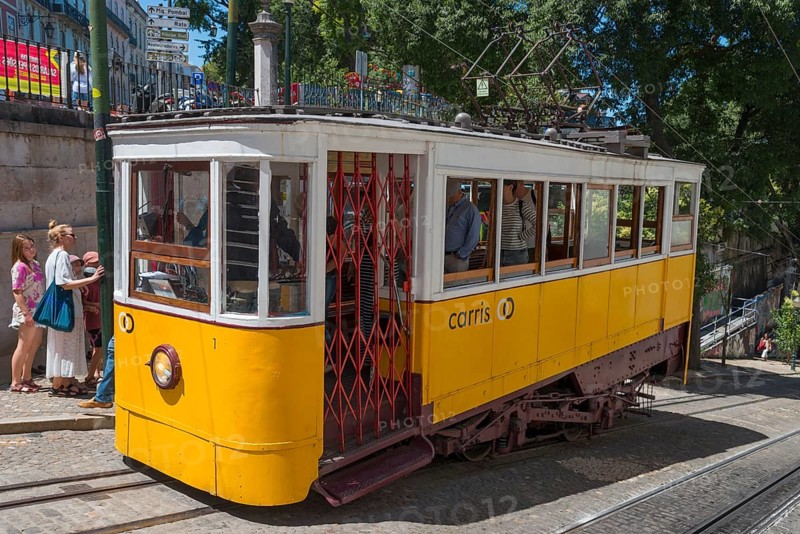 Yellow tram full of passengers in summer in an urban environment, funicular railway, Ascensor da Glória, Old Town, Lisbon, Lisboa, Portugal, Europe