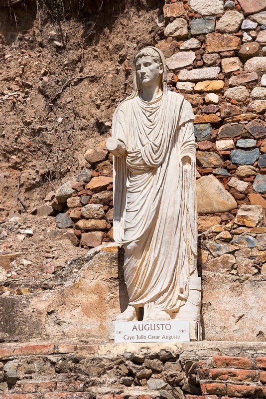 Statue of Augustus in front of a colourful stone wall, symbolising Roman history and ancient art, Mérida, Merida, Badajoz, Extremadura, Spain, Europe