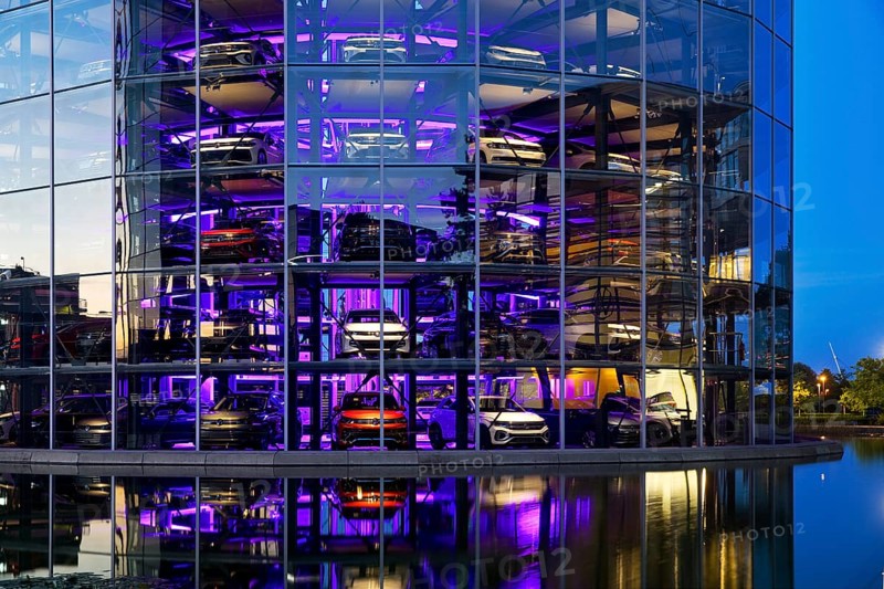 An illuminated car tower with new cars for delivery in the evening, detail, Autostadt, Volkswagen AG, Wolfsburg, Lower Saxony, Germany, Europe