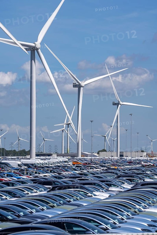 Storage area for new cars in the port of Vlissingen-Oost, vehicles are temporarily stored on over 100 hectares to ship them from Europe to the United Kingdom, Ford cars, others such as models from the Chinese car manufacturer BYD are delivered from here in Europe, wind farm, Netherlands
