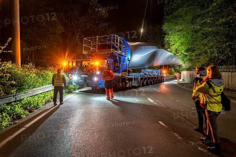 Transport of a 68 metre long, 22 tonne blade of a wind turbine, here in Schwelm, with a self-propelled Blade-Lifter vehicle, over a 40 km long route, over 2 nights, in the Bergisches Land, through towns, villages, over country roads, narrow through roads, to the construction site of the wind turbine near Hagen, North Rhine-Westphalia, Germany, Europe