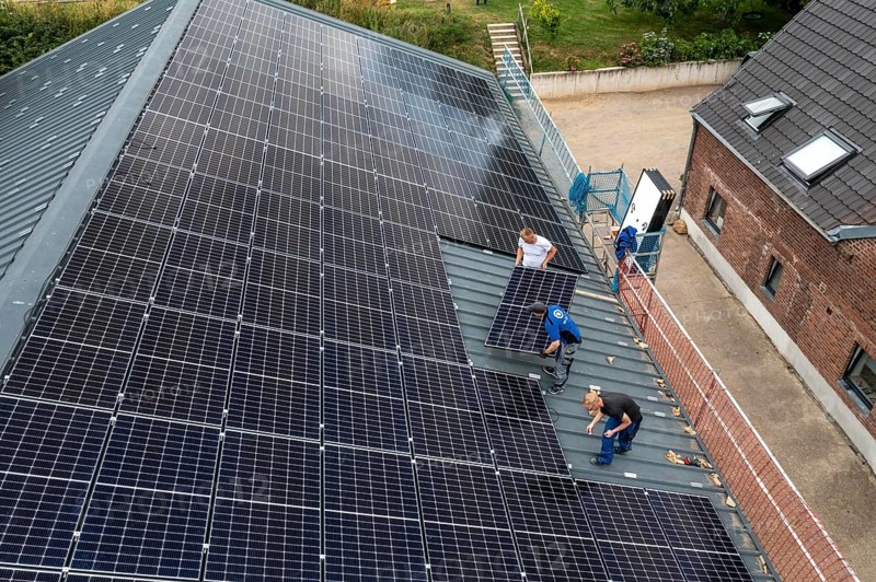 Installation of solar modules on the roof of a barn on a farm, over 210 photovoltaic modules are installed on the roof, North Rhine-Westphalia, Germany, Europe