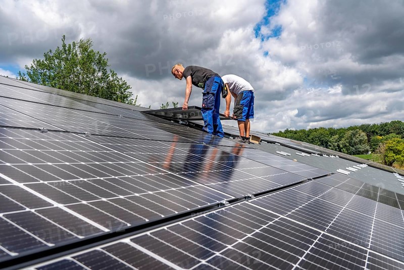 Installation of solar modules on the roof of a barn on a farm, over 210 photovoltaic modules are installed on the roof, North Rhine-Westphalia, Germany, Europe