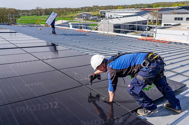 Installation of solar modules on the roof of a commercial enterprise, over 400 photovoltaic modules are installed on the roof, North Rhine-Westphalia, Germany, Europe