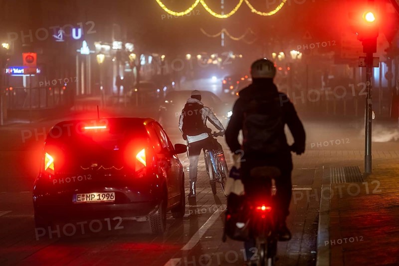 Cyclist, darkness, inner city traffic, Rüttenscheider Straße, bicycle lane, fog, autumn, winter, evening traffic, North Rhine-Westphalia, Germany, Europe