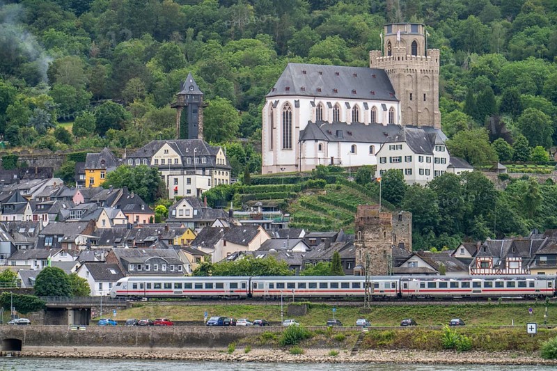 Left bank of the Rhine railway line in the Upper Middle Rhine Valley, near Oberwesel, IC train passing through the town, St Martin's Church, Rhineland-Palatinate, Germany, Europe