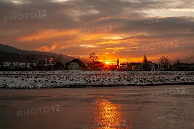 Sunset reflected in the asphalt of a car park, near Krieglach, Styria, Austria, Europe