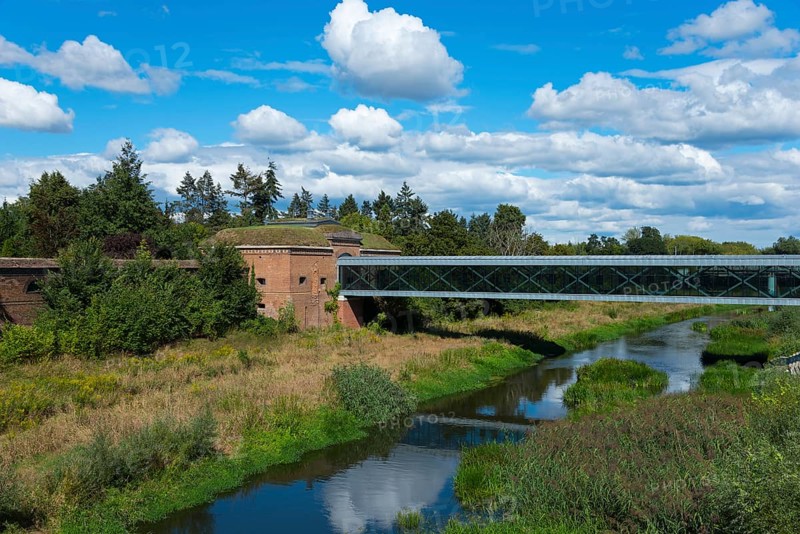 Natural landscape with a bridge over a river and lush greenery under a cloudy sky, view from the Bishop Jordan Bridge, Cybina River, Poznan, Posnan, Poznan, Greater Poland Voivodeship, Poland, Europe