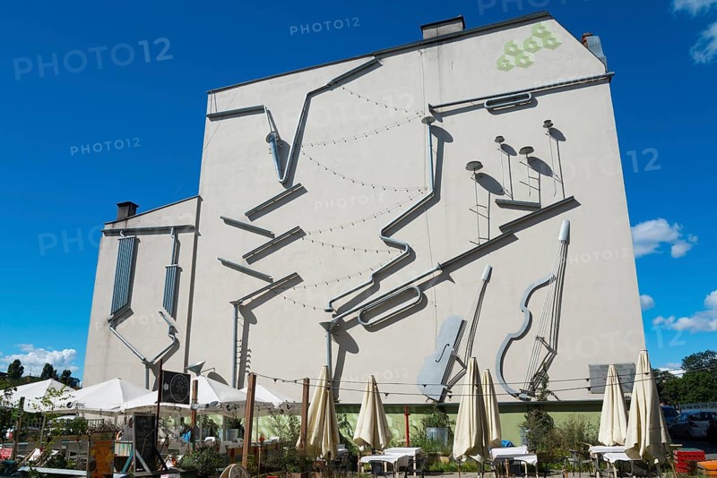 Façade of a building with large, attached instruments as an art installation, mural, Green Symphony installation, Poznan, Posnan, Poznan, Greater Poland Voivodeship, Poland, Europe