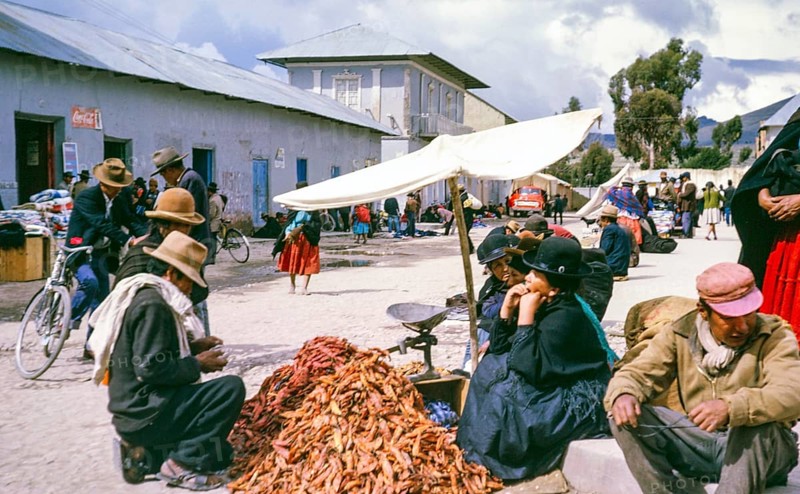 Subtitle: Border town Peru possibly Puno, Peru, South America, 1962 Street market with a pile of chilli peppers, South America
