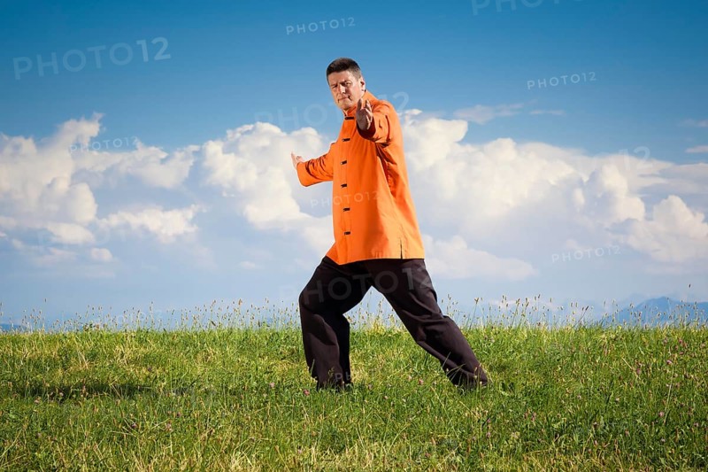 A man doing Qi-Gong in the green nature