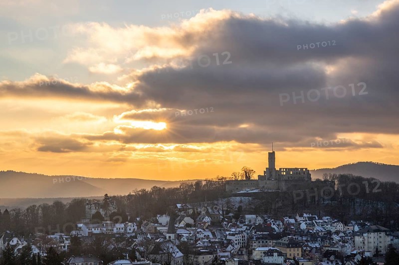 Viewpoint and landscape shot in the evening at sunset. Cold weather and light snow at Schlossblick. View to the castle and over a village in winter near Frankfurt Königstein, Taunus, Hesse, Germany, Europe