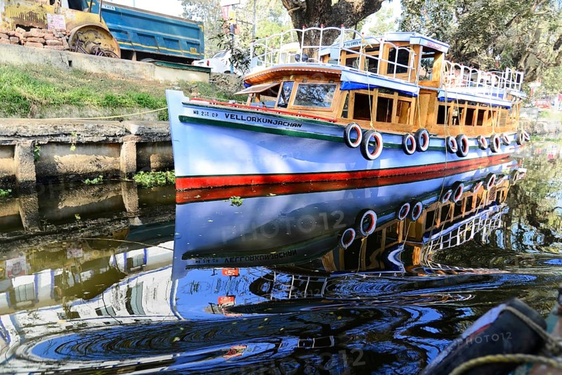 Fort Cochin, Cochin, Kerala, South India, India, Asia, Blue traditional boat reflected in the calm waters of a canal, Kovalam, Malabar Coast, Malabar, Asia