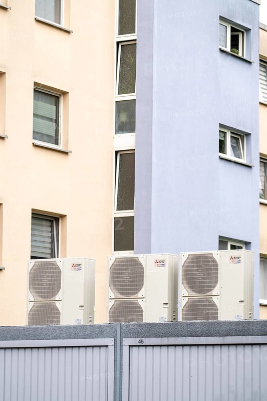 Heat pumps in a residential area, multi-family houses are supplied with heating, cooling and domestic hot water via these devices, installed on garage roofs, modernisation of the flats, Duisburg, North Rhine-Westphalia, Germany, Europe