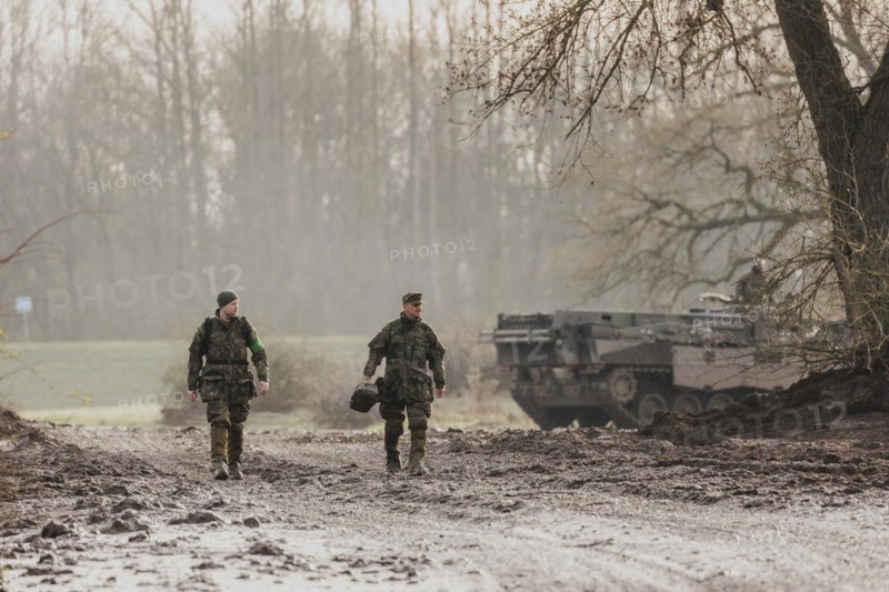 Two soldiers walking on a muddy path, taken as part of the military exercise 'Wettiner Schwert' with German and Czech soldiers near Tangermünde, 26 March 2024. 'Wettiner Schwert' is part of the NATO Quadriga exercise