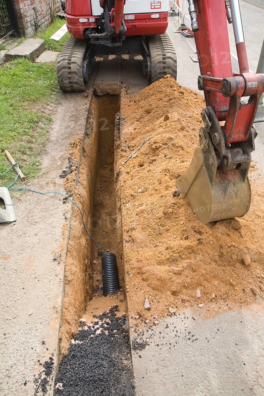 Digging a trench to take electricity supply cables underground, Shottisham, Suffolk, England, United Kingdom, Europe