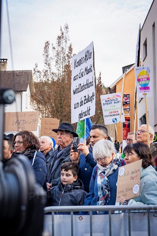 Demonstrators with signs showing political messages behind barriers, demonstration against the right, Nagold, Black Forest, Germany, Europe
