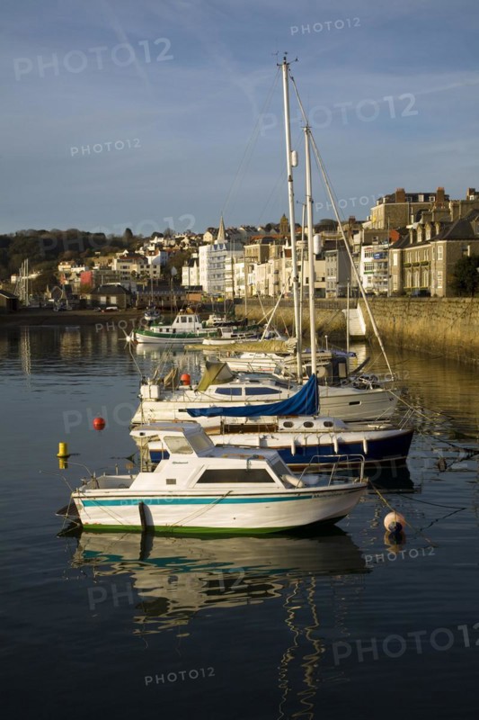 Boats in the harbour and the town of St Peter Port, Guernsey, Channel Islands, UK, Europe