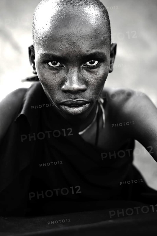Portrait of a teenage boy from the Njemps tribe, Kenya. He is following his initiation rite. Once completed, he will be considered as a warrior. Black and white photography
