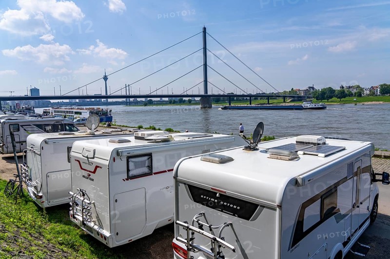Motorhome parking space on the banks of the Rhine, Düsseldorf skyline on the Rhine, Rhine Tower, Oberkassler Bridge, motorhome parking space on the banks of the Rhine, Rhine terrace, Düsseldorf, North Rhine-Westphalia, Germany, Europe
