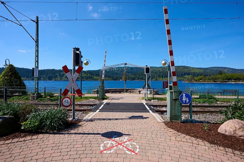 Railway crossing at Schluchsee and blue sky, embedded in a mountain landscape, Schluchsee, Black Forest, Baden-Württemberg, Germany, Europe
