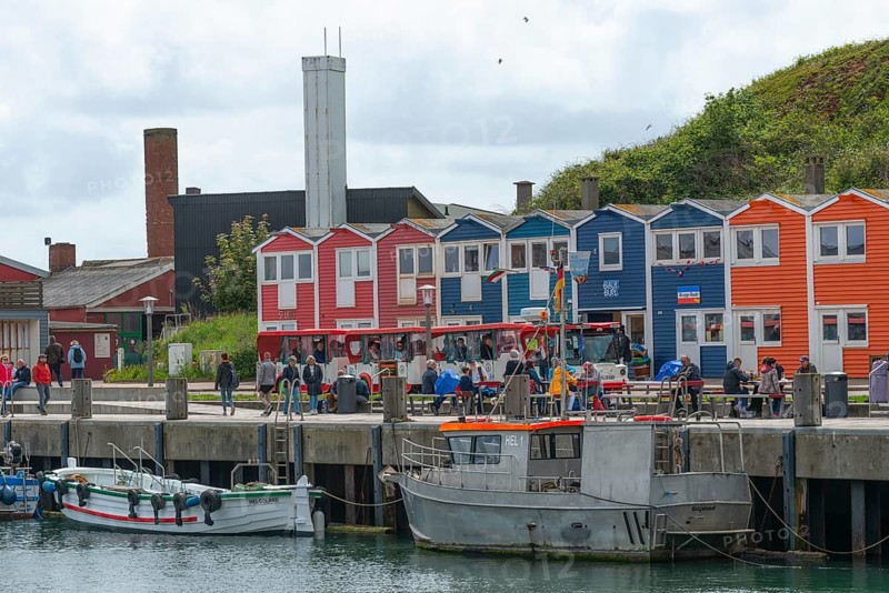 Colourful lobster shacks in the lowlands, promenade, shops, harbour with boats, many people, tourism, island bus, round trip, architecture, offshore island of Heligoland, North Sea, Pinneberg district, Schleswig-Holstein, Germany, Europe