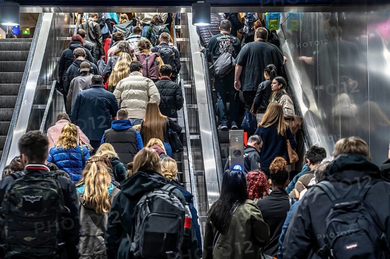 Public transport, underground, main station exit, many people crowding out of the underground station at rush hour in the afternoon, via stairs and escalators, North Rhine-Westphalia, Germany, Europe