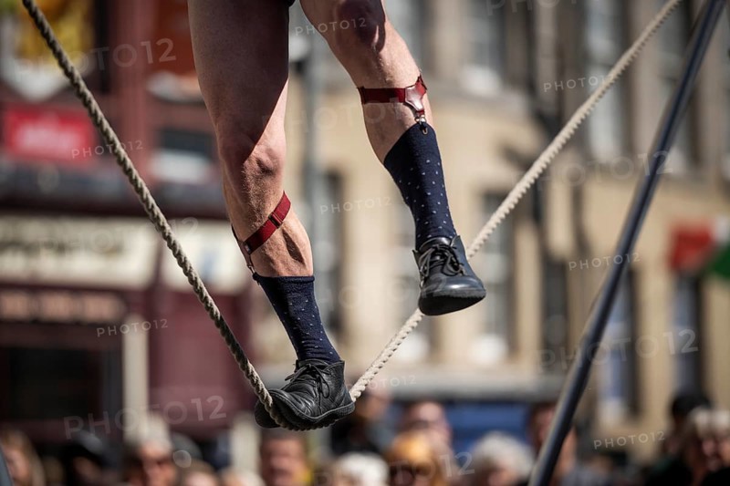 Feet balancing on a tightrope, street artists performing high-wire acrobatics, world's largest cultural festival The Fringe, High Street, Edinburgh, Scotland, United Kingdom, Great Britain, Europe