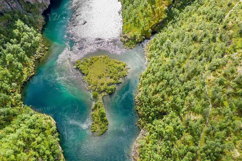 Aerial view of an island in a turquoise colored river surrounded by birch forest, valley Aurlandsdalen, Norway, Europe