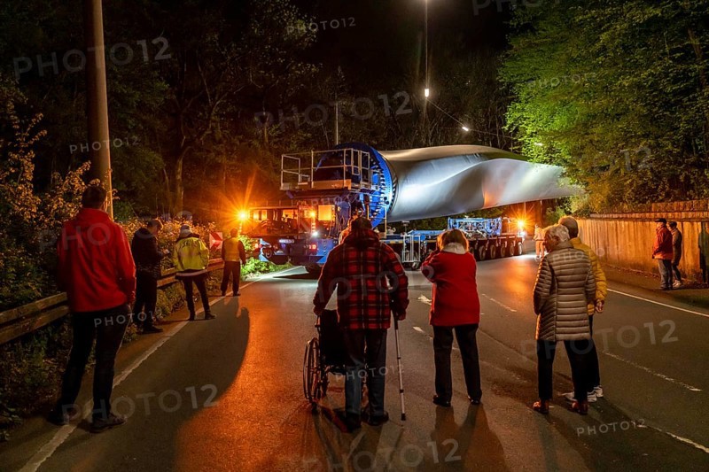 Transport of a 68 metre long, 22 tonne blade of a wind turbine, here in Schwelm, with a self-propelled Blade-Lifter vehicle, over a 40 km long route, over 2 nights, in the Bergisches Land, through towns, villages, over country roads, narrow through roads, to the construction site of the wind turbine near Hagen, North Rhine-Westphalia, Germany, Europe