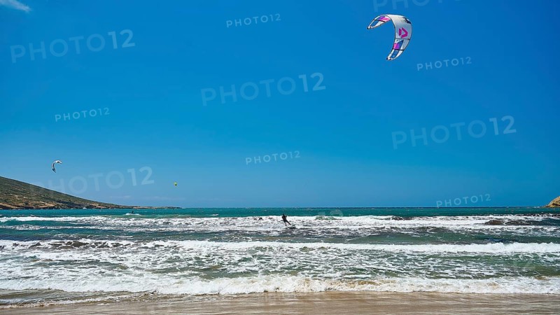 Kitesurfer on wavy sea under blue sky with kite, surfer's paradise, kitesurfer, windsurfer, Prasonisi, island in the south of Rhodes, Rhodes, Dodecanese, Greek Islands, Greece, Europe