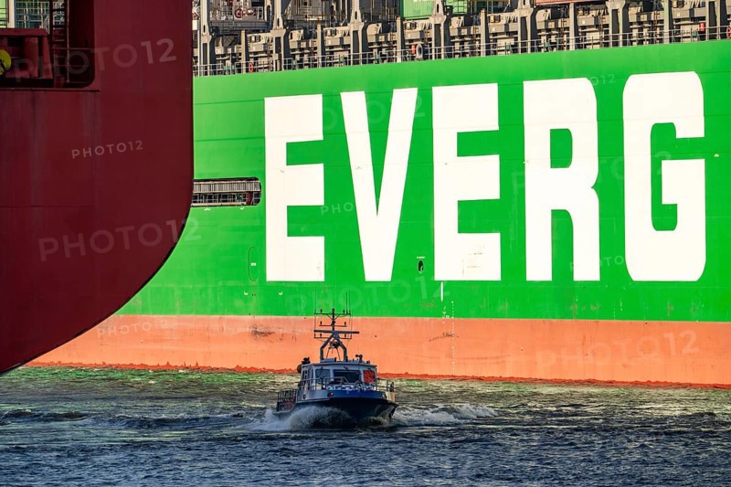 Container ship Ever Gifted, in the port of Hamburg, Waltershofer Hafen, HHLA Container Terminal Burchardkai, water police boat, Evergreen shipping company, Singapore, 399 metres long, can carry over 20, 000 containers, Hamburg, Germany, Asia