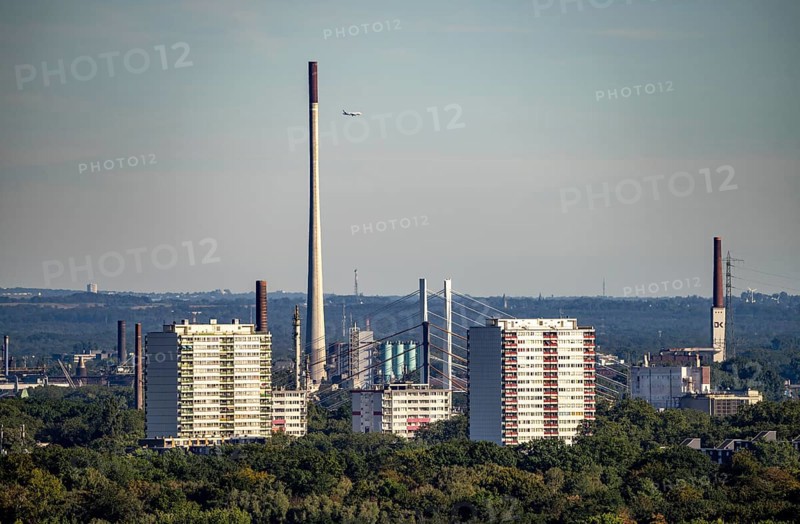 View over Duisburg-Hochheide, high-rise residential buildings, behind the old and new motorway bridge Neuenkamp, chimneys of DK Recycling and Roheisen, from northwest, much green forest areas, North Rhine-Westphalia, Germany, Europe