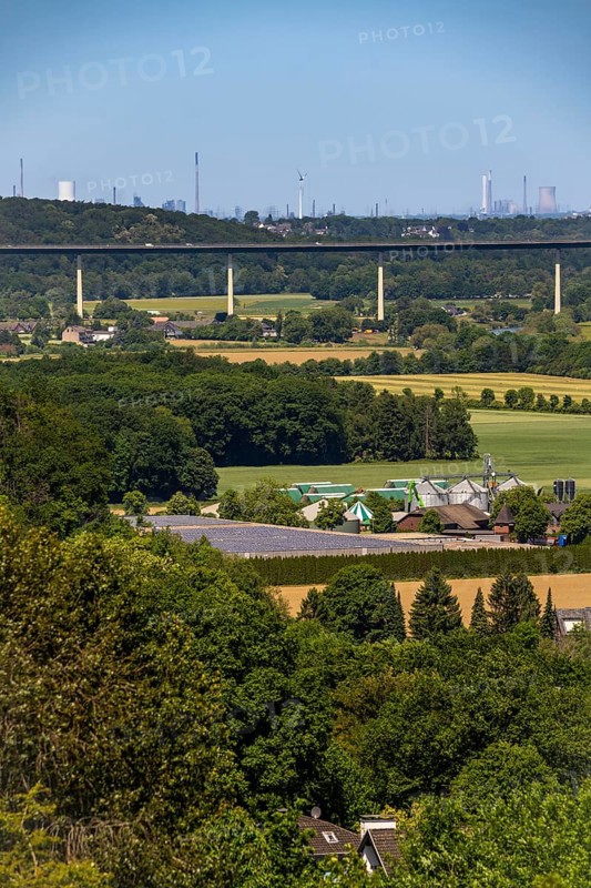 The Ruhr valley between Essen-Kettwig and Mülheim-Mintard, view to the west, Ruhr valley bridge of the A52 motorway, industrial backdrop of Duisburg, in the middle the decommissioned Voerde coal-fired power station, in front a biogas plant on a farm in Kettwig, North Rhine-Westphalia, Germany, Europe