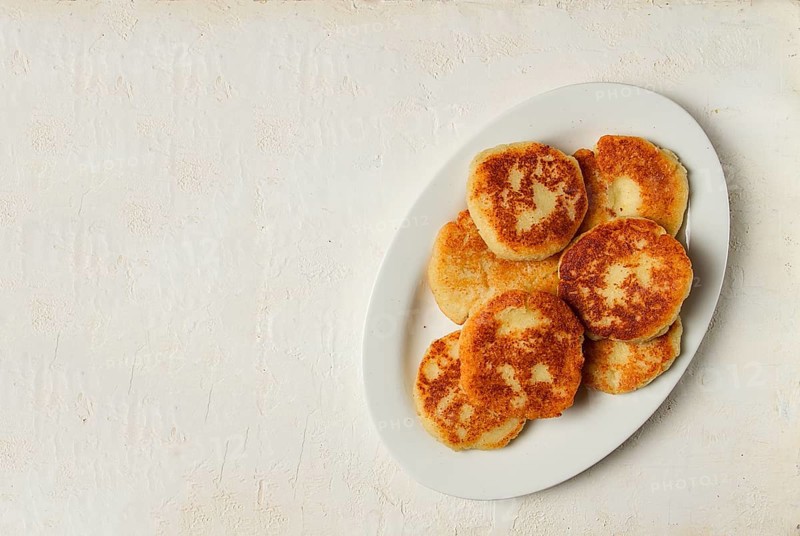 Chvishtari, corn flour tortillas with cheese, pastries, Georgian cuisine, Mchadi, homemade, top view, on a wooden table, no people
