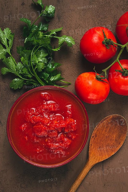 Tomatoes in their own juice, sliced, tomato sauce, tomatoes, in a cup, top view, close-up, no people