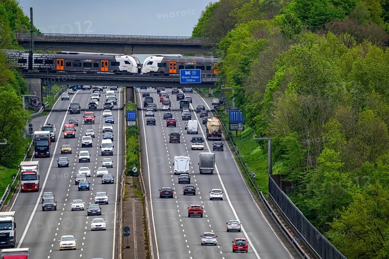 Rhein-Ruhr-Express, RRX train, crossing the A3 motorway, traffic on 8 lanes, including the temporarily released hard shoulder, behind the Hilden motorway junction, view in south direction, near Erkrath, North Rhine-Westphalia, Germany, Europe