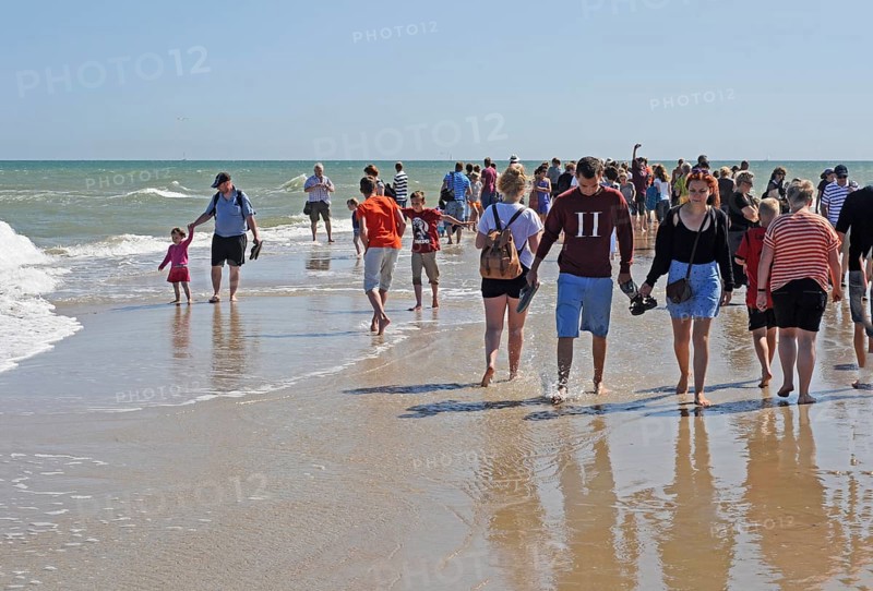 Ttourists standing at the northern tip of Denmark where the Baltic Sea and North Sea meet at Skagen Reef, Skagen gren, Jutland, Denmark, Scandinavia, Europe
