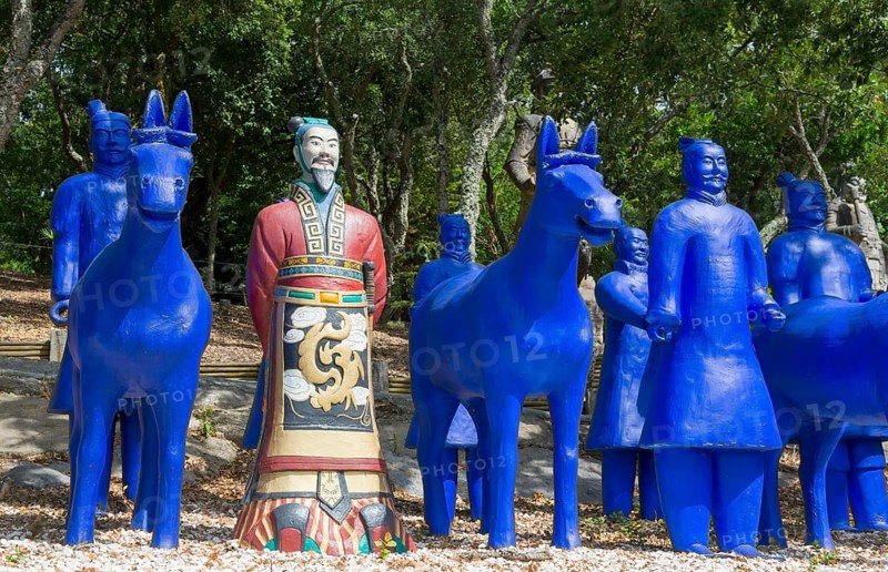 Blue terracotta soldiers and horse statues with a painted soldier in a forest, Bacalhôa, Bacalhoa Buddha Eden, Quinta dos Loridos, largest oriental garden in Europe, Bombarral, Oeste, Centro, Portugal, Europe