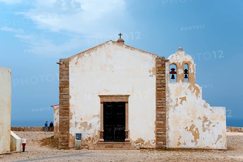 A historic chapel with bell tower and views of the ocean, surrounded by ancient walls, Igreja de Nossa Senhora da Graça, Church of Our Lady of Grace, Fortaleza de Sagres, Sagres sea fortress, Ponta de Sagres, Sagres, Faro, Algarve, Portugal, Europe