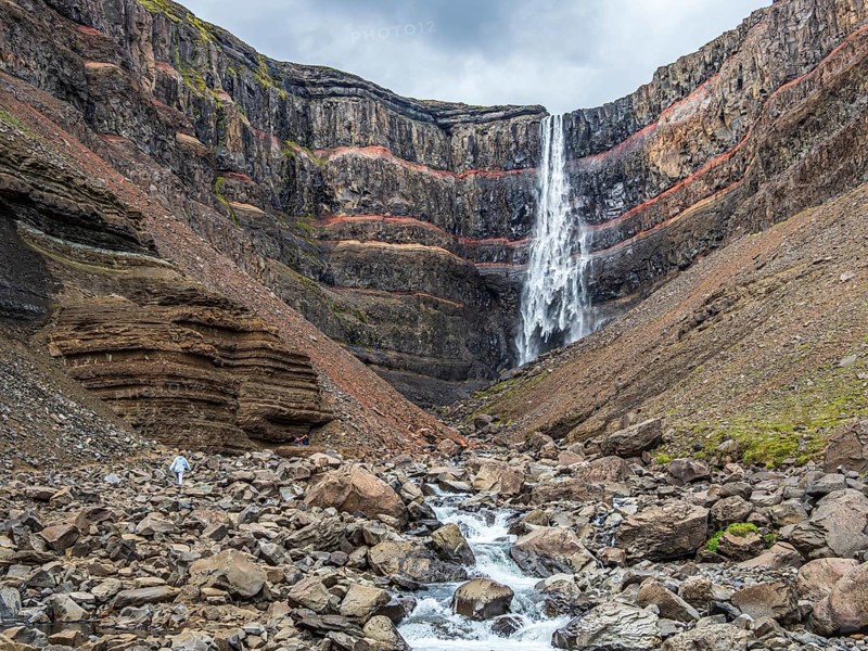 Waterfall Hengifoss, basaltic layers interwoven with red sedimentary layers, Iceland, Europe