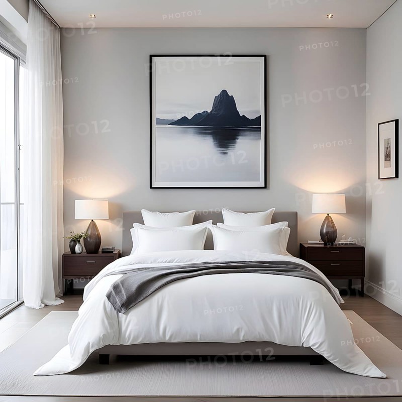 Empty modern bedroom with a large, plush bed covered in white linens, a single framed artwork on the wall, and natural light filtering through sheer curtains, AI generated