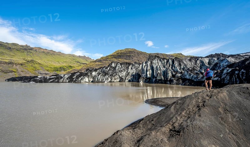 Tourist on the shore of a glacier lagoon, glacier tongue and lake, Sólheimajökull, South Iceland, Iceland, Europe