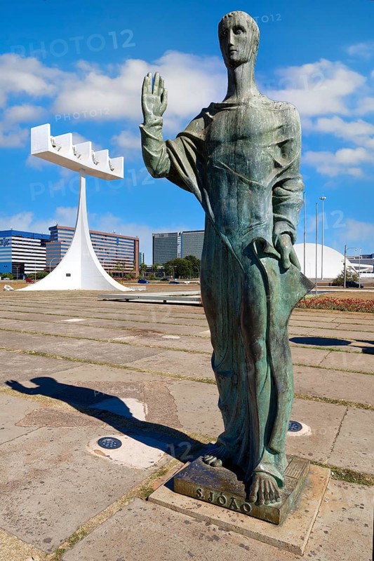St John the Evangelist statue by Alfredo Ceschiatti and Dante Croce in front of the bell tower of Roman Cathedral of Brasília or Metropolitan Cathedral, designed by Oscar Niemeyer, World Heritage Site, Brasilia, Federal district, Brazil, South America