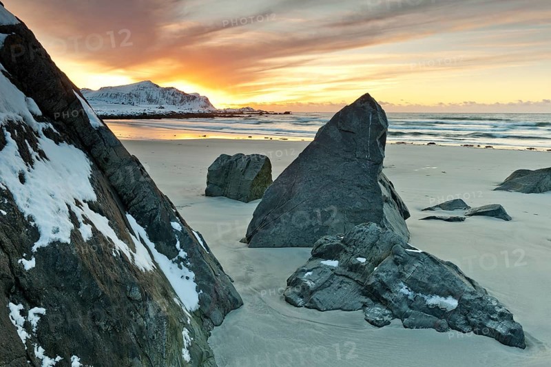 Sunset in winter at Skagsanden, stones on the beach at Flakstad, Flakstadøy, Lofoten, Nordland, Norway, Europe