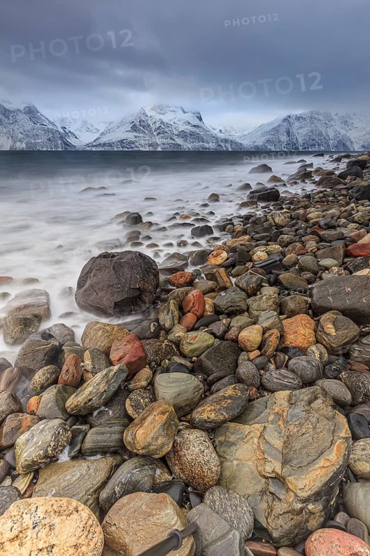 Stones, coast, sea, waves, mountains, winter, snow, cloudy, windy, long exposure, Lyngen Alps, Norway, Europe